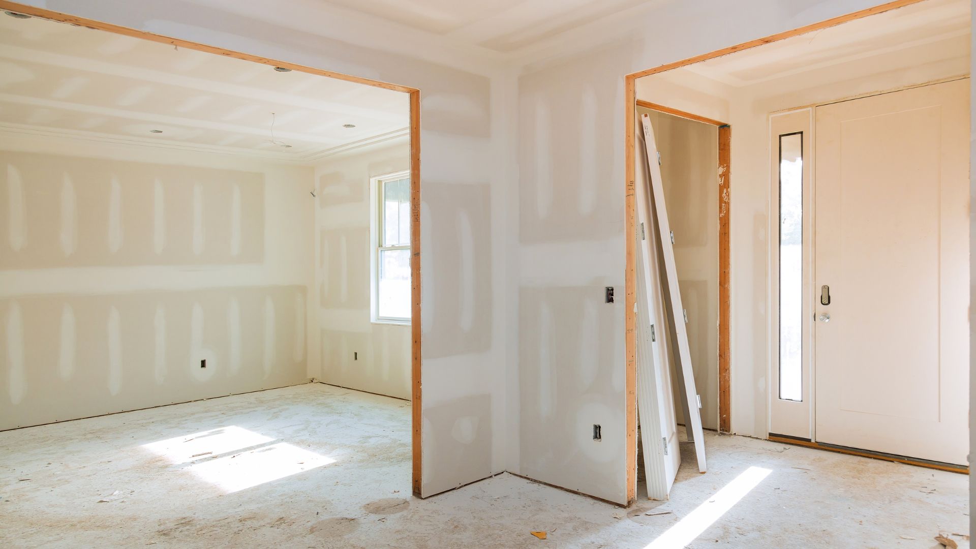 An empty room with a door and a window