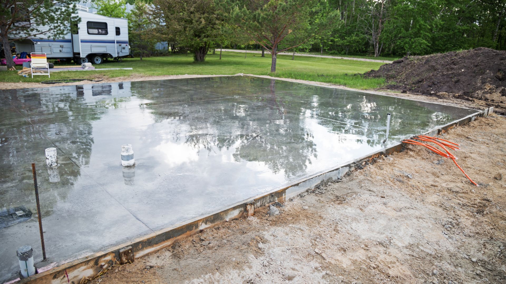A large pool being built in the middle of a field