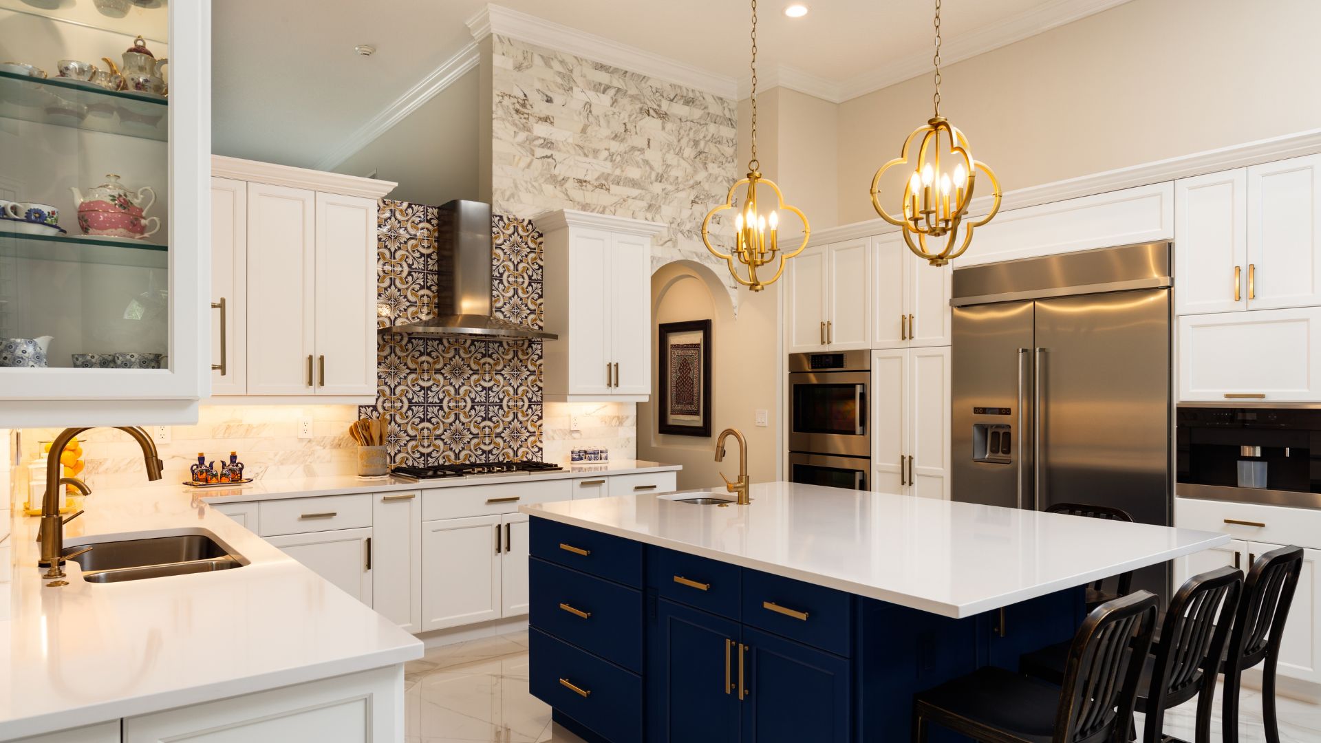A kitchen with white cabinets and blue island